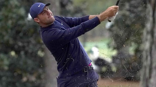Second-round leader Scottie Scheffler hits at the 2022 Masters.